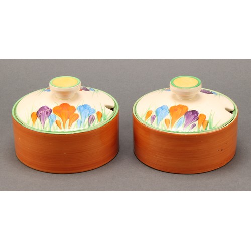 3010 - A pair of Clarice Cliff Crocus pattern compressed circular preserve jars and covers, 7cm high, Newpo... 