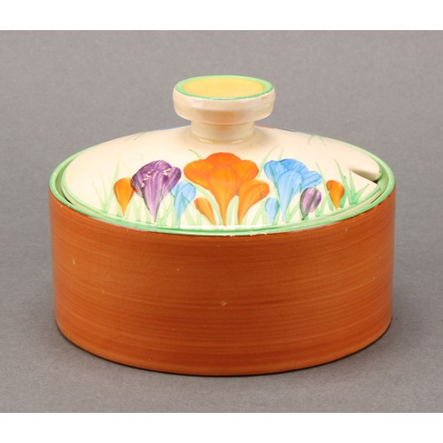 3010 - A pair of Clarice Cliff Crocus pattern compressed circular preserve jars and covers, 7cm high, Newpo... 