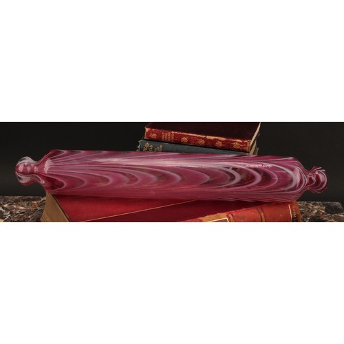 3225 - A Nailsea pink and white opaque glass rolling pin, 42cm