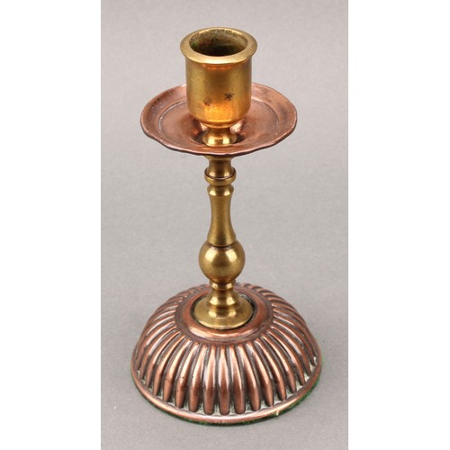 3337 - A pair of Arts and Crafts copper and brass candlesticks, in the Christopher Dresser taste, 15cm high... 