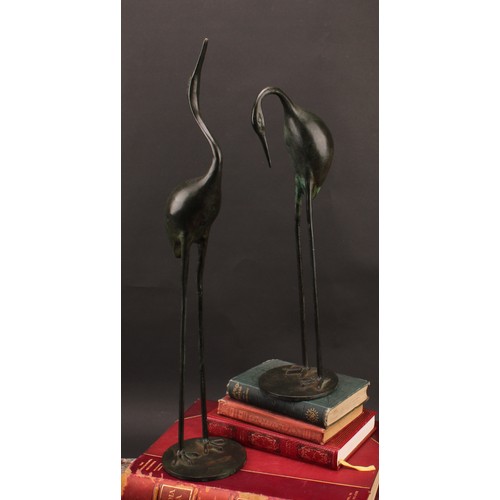 3399 - Modern School, a pair of verdigris patinated bronzes, of cranes, circular bases, 53.5cm and 40cm hig... 