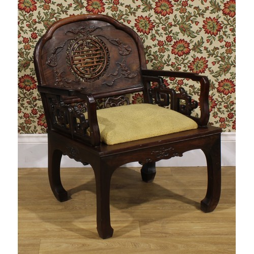 3410 - An Art Deco period Chinese hardwood elbow chair, shaped back carved with bats and coins and centred ... 