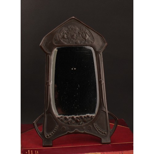 3362 - An Art Nouveau copper easel dressing table mirror, embossed with young girls in allusion to the Thre... 