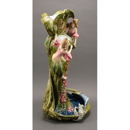 3030 - A large Continental art pottery vase, modelled with young girls beside a fountain, the pool edge wit... 