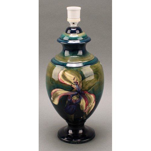 3125 - A Moorcroft Orchid pattern ovoid pedestal table lamp, tube lined with large flowerheads in tones of ... 