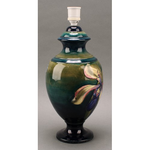 3125 - A Moorcroft Orchid pattern ovoid pedestal table lamp, tube lined with large flowerheads in tones of ... 