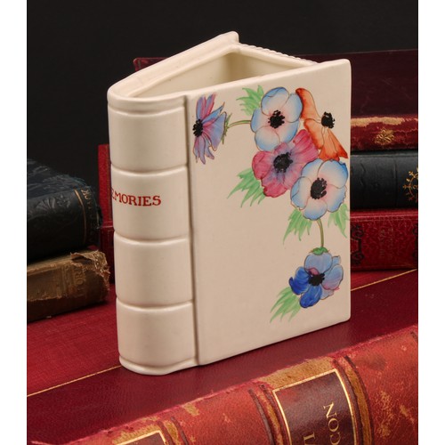 3014 - A Clarice Cliff Memories book vase, hand painted with flowers, the spine inscribed ‘Memories’, 12cm ... 