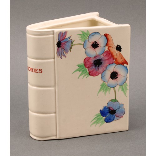 3014 - A Clarice Cliff Memories book vase, hand painted with flowers, the spine inscribed ‘Memories’, 12cm ... 