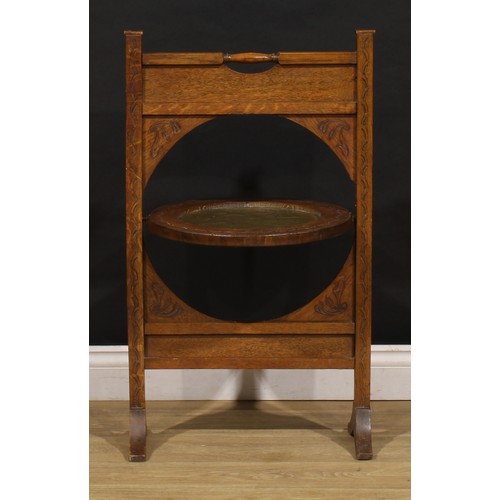 3413 - An Arts and Crafts period oak and brass metamorphic combination fire screen and table, the circular ... 