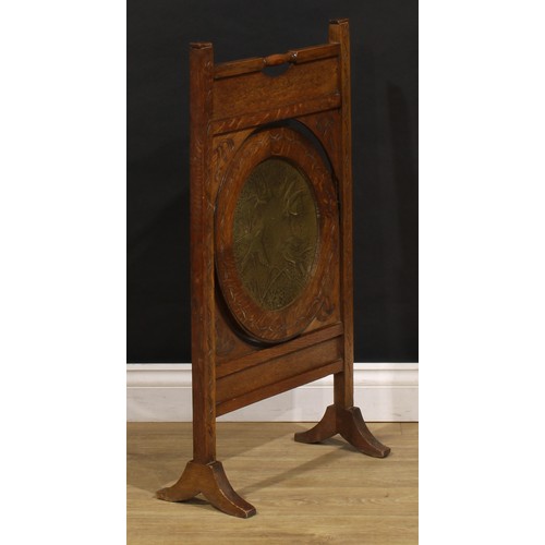 3413 - An Arts and Crafts period oak and brass metamorphic combination fire screen and table, the circular ... 