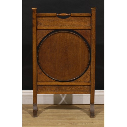 3413 - An Arts and Crafts period oak and brass metamorphic combination fire screen and table, the circular ... 