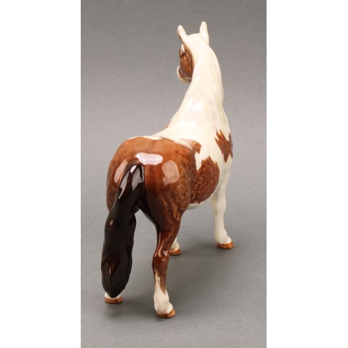 3078 - A Royal Doulton model of an Appaloosa horse, 20cm, printed mark; a Beswick skewbald Pinto pony, 17cm... 