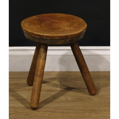 3347 - A pair of Art Deco design ash and elm tripod stools, probably Welsh, each top covered in tooled leat... 