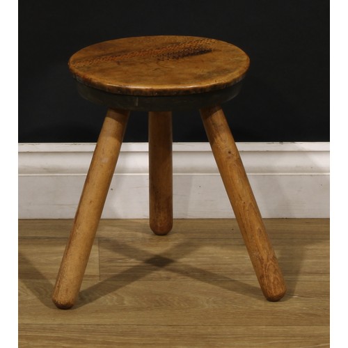 3347 - A pair of Art Deco design ash and elm tripod stools, probably Welsh, each top covered in tooled leat... 