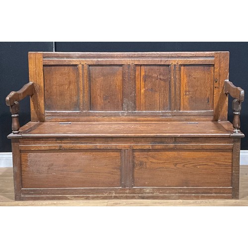 105 - An 18th century and later oak box settle, four panel back, hinged seat, 93.5cm high, 147cm wide, 52c... 