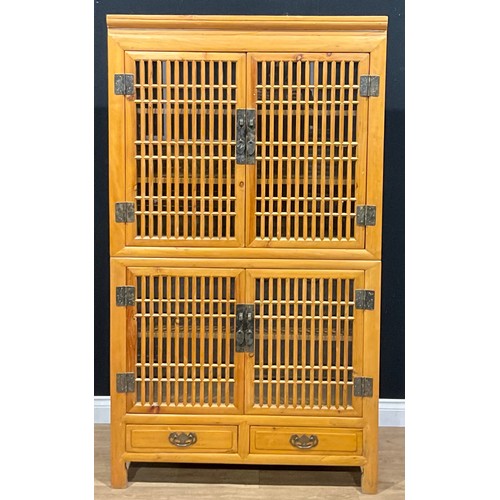 107 - A Chinese design pine enclosed bookcase or side cabinet, drawers to base, 174.5cm high, 99cm wide, 4... 