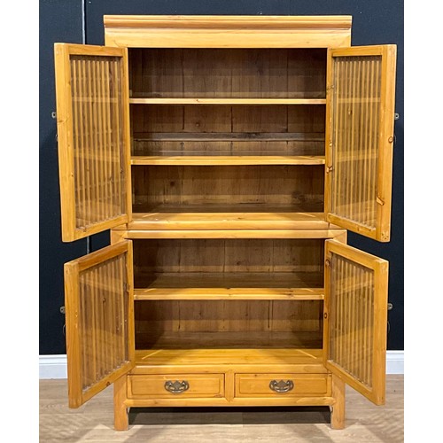 107 - A Chinese design pine enclosed bookcase or side cabinet, drawers to base, 174.5cm high, 99cm wide, 4... 