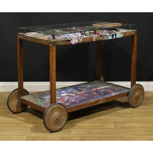 3343 - A mid-20th century artist’s studio table, glazed rectangular top enclosing an accumulation of discar... 