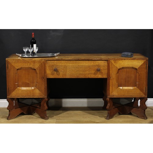 3374 - An Arts & Crafts oak sideboard, by Arthur Romney Green (1872-1945), flush rectangular top above a ce... 