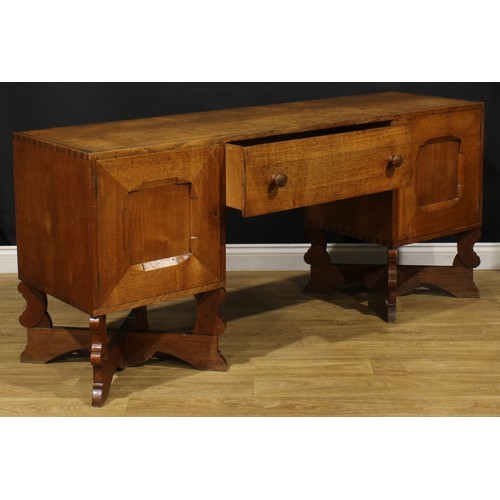 3374 - An Arts & Crafts oak sideboard, by Arthur Romney Green (1872-1945), flush rectangular top above a ce... 