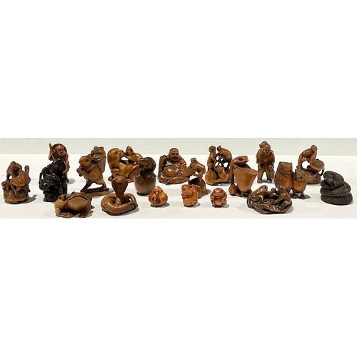 461 - Oriental - a collection of Japanese carved hardwood netsuke, including owls, frogs, figures, snakes,... 