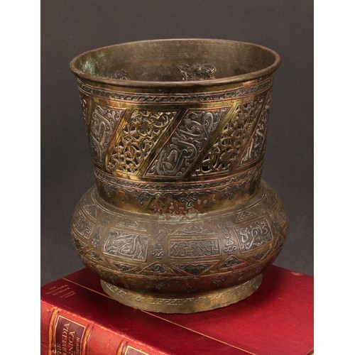 472 - A Middle-Eastern silvered and copper damascened brass mosque lamp, pierced and decorated with Arabic... 