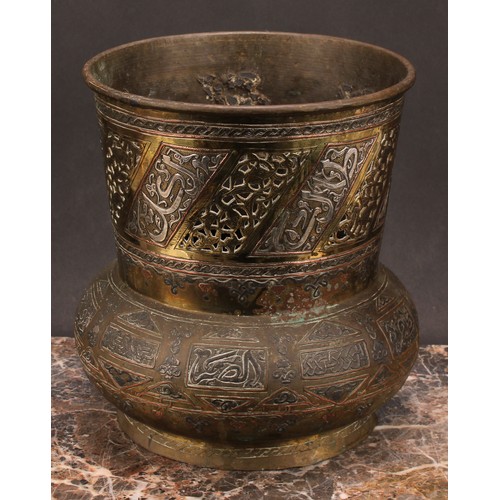 472 - A Middle-Eastern silvered and copper damascened brass mosque lamp, pierced and decorated with Arabic... 