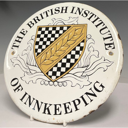 481 - An enamel sign wall plaque, The British Institute of Innkeeping, 23cm diameter