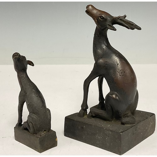 493 - A Chinese patinated bronze desk seal, in the form of an interlocking deer and faun, 11.5cm high