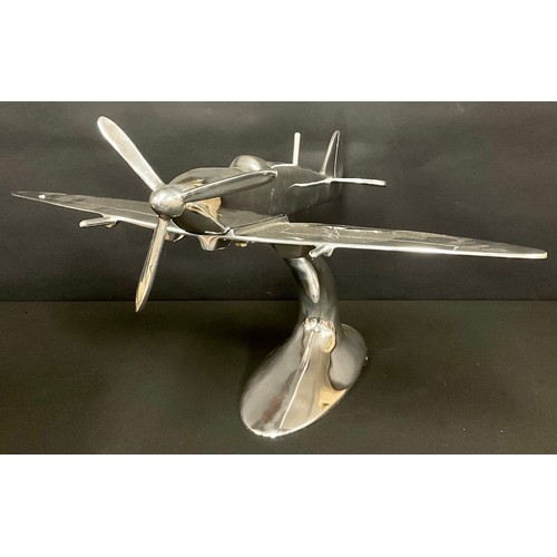 494 - A large polished metal desktop model, as a Spitfire, 60cm long, 50cm wide, 30cm high