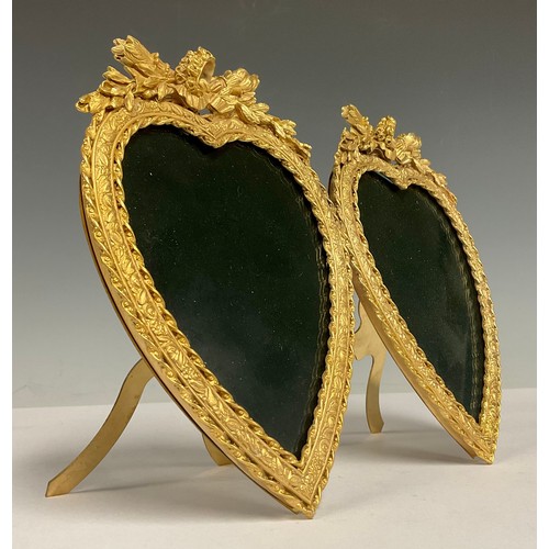 496 - A reproduction Louis XVI style gilt brass double love heart shaped photograph frame, the crests carv... 