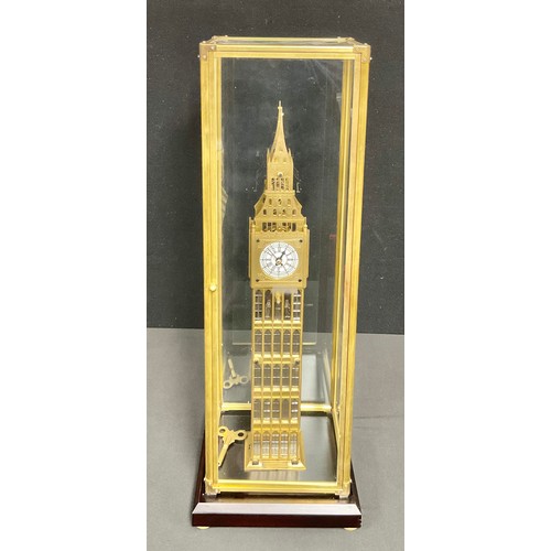 510 - A contemporary glass cased Big Ben skeleton clock and key, on wooden plinth, 69cm high overall