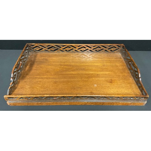 511 - A George III style serving tray, the fretwork gallery in the cockpen manner, 76.5cm wide