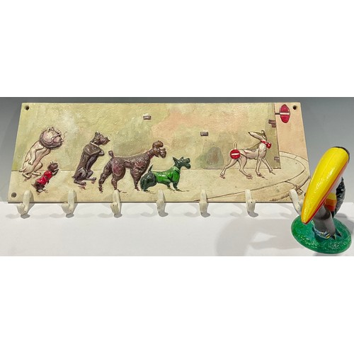 515 - A cast iron coat rack, cast with dogs in the manner of Boris O'Klein, 50cm wide; a cast iron Guinnes... 