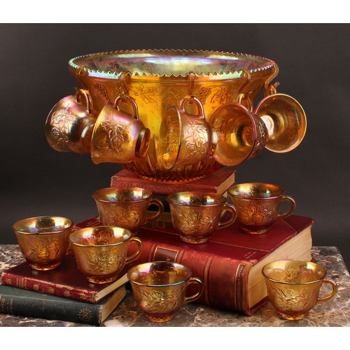 2405 - A carnival glass punch set, comprising a bowl and twelve cups, press moulded with fruiting vine, 31.... 