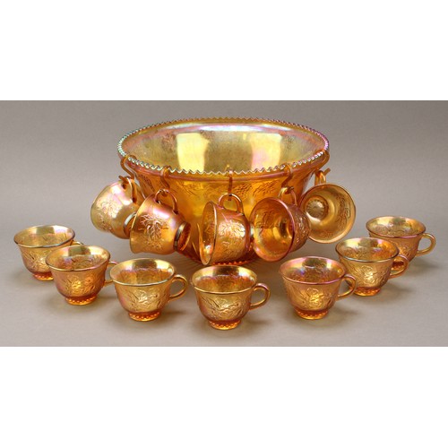 2405 - A carnival glass punch set, comprising a bowl and twelve cups, press moulded with fruiting vine, 31.... 