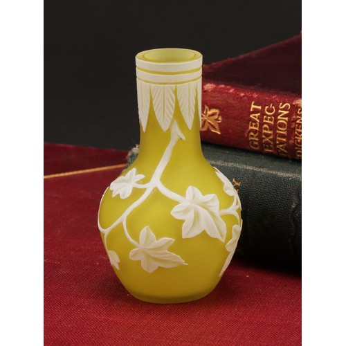 2467 - A miniature cameo glass vase, in the manner of Thomas Webb, decorated with trailing ivy on a yellow ... 