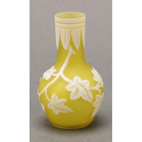 2467 - A miniature cameo glass vase, in the manner of Thomas Webb, decorated with trailing ivy on a yellow ... 