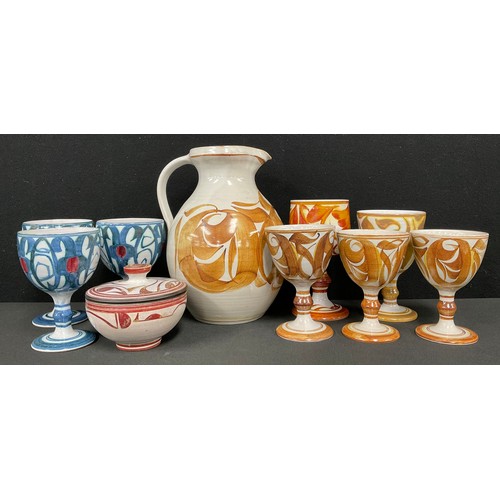 2452 - An Aldermaston Pottery ale set, comprising a jug and four goblets, designed by Angela Monkton, the j... 