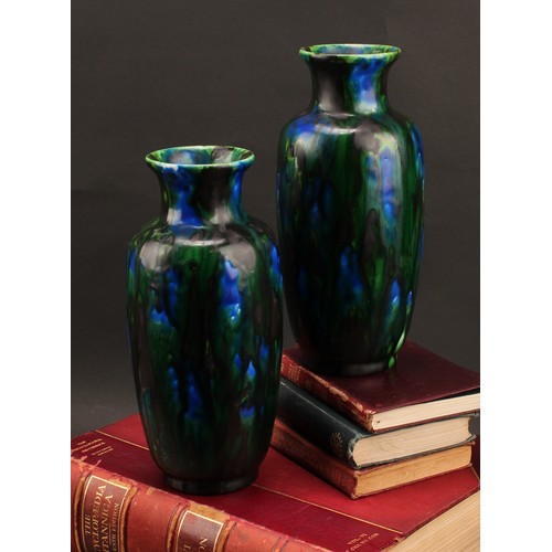 2433 - A pair of Minton, Hollins & Co. ovoid vases, Astra Ware vases, drip glazed in peacock feather tones,... 