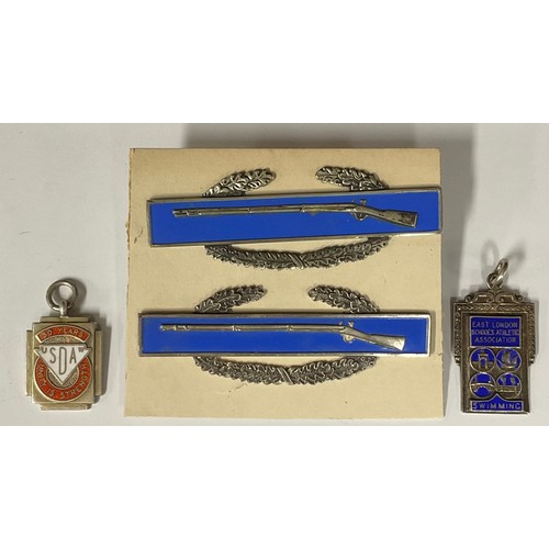 5137 - Two Sterling silver and enamel rifle badges; two silver and enamel fobs