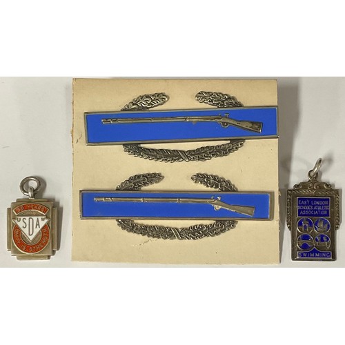 5137 - Two Sterling silver and enamel rifle badges; two silver and enamel fobs