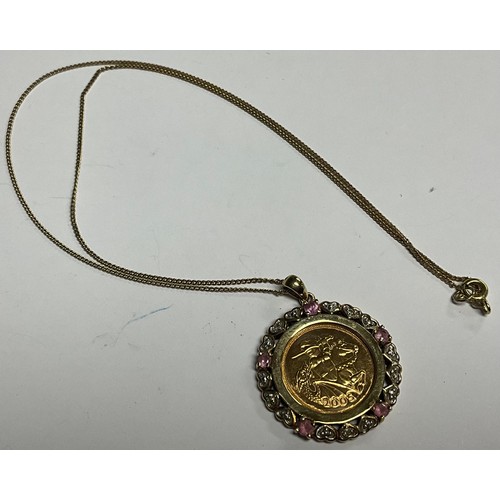5150 - A half soverign, 2005, in mount set with diamond chips and pink stones, 9ct gold chain, 10.9g gross