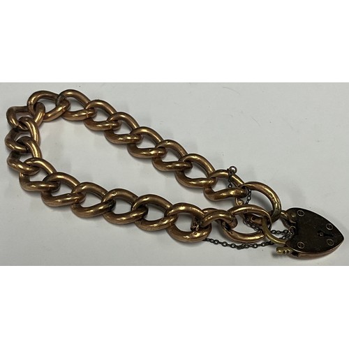 5167 - A 9ct gold curb link bracelet, padlock clasp, 20.4g gross