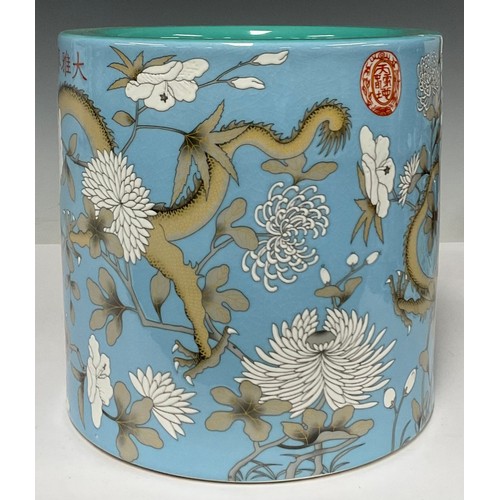 5485 - A large Chinese porcelain pale blue and celadon brush pot, decorated with dragons and foliate motifs... 