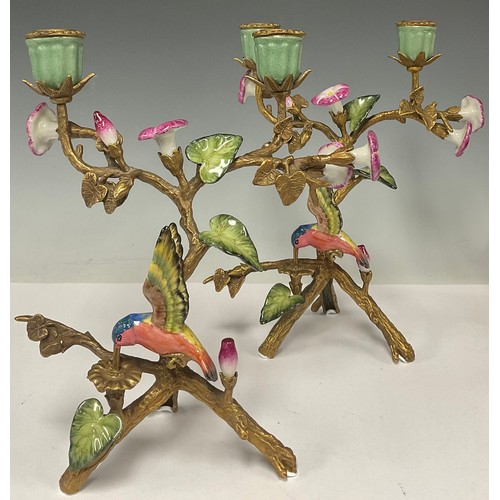 5486 - A pair of gilt bronze two light candelabra, decorated with humming birds and flowers, 25.5cm high