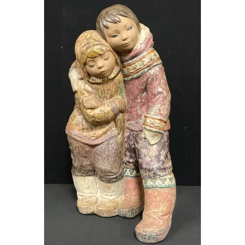 5488 - A large Lladro figure group of an Eskimo boy and girl, No. 2038 designed by Juan Huerta, 38cm high.