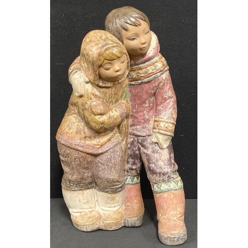 5488 - A large Lladro figure group of an Eskimo boy and girl, No. 2038 designed by Juan Huerta, 38cm high.