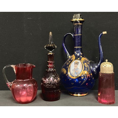 5489 - Turkish wine jug, two portrait panels; cranberry jug; sifter; a bohemian red glass decanter (4)