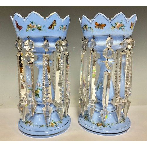 5495 - A pair of Victorian blue opaque glass table lustres, painted with a band of stylised blossom and but... 